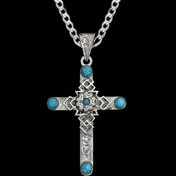 This beautiful pendant is perfect for turquoise lovers! The Timothy Cross necklace is hand-crafted with German Silver and features turquoise stones along with a unique floral and abstract central figure. 1.5”x2”